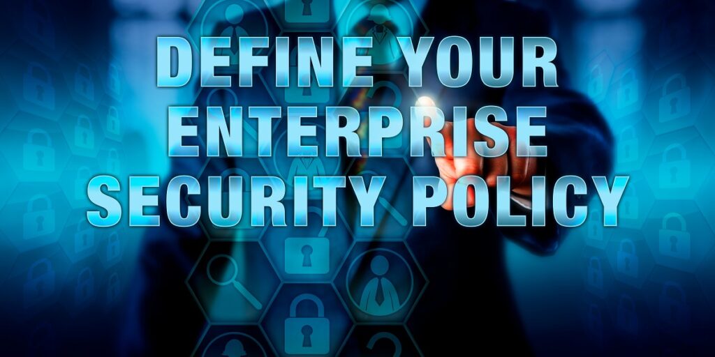 Manager is pushing DEFINE YOUR ENTERPRISE SECURITY POLICY on a visual interactive display. Business challenge metaphor and information technology concept for cybersecurity standards and planning.